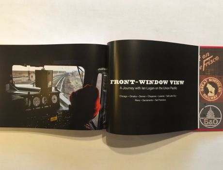 In a colour photograph taken through the windscreen of a Union Pacific diesel locomotive, the engineer in a red woolly hat drives the train west across the prairies, dials and control panels laid out in front of him, tracks stretching ahead round a gentle curve. The railfan designer Ian Logan was invited to ride in the cab of the California Zephyr from Chicago to San Francisco, taking this and other photographs as he went.