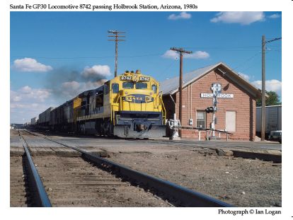 In this colour photograph taken by the railfan designer Ian Logan in the 1980s, the Santa Fe GP30 locomotive 8742 belches its way through Holbrook, Arizona, at the head of a freight train, the company’s circle-and-cross logo elongated to adorn the nose and its livery instantly identifiable by the characteristic combination of dark blue and yellow. 