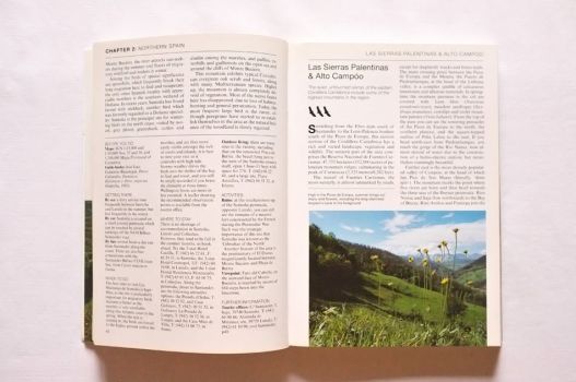 Pages with travel tips for northern Spain and a photograph of a meadow in the Picos de Europa.
