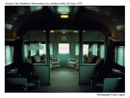 In this colour photograph taken in St Louis in 1972 by the railfan designer Ian Logan, the interior of an observation car built by Pullman for the Kansas City Southern Railway’s Southern Belle is warmed by subdued lighting, furnished with chromed-steel and leather armchairs, hung with curtains and Venetian blinds and embellished with engraved glass panels. 