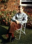 Colour photograph of Adam Hart-Davis sitting in the garden of the family home in Nettlebed, 1962.