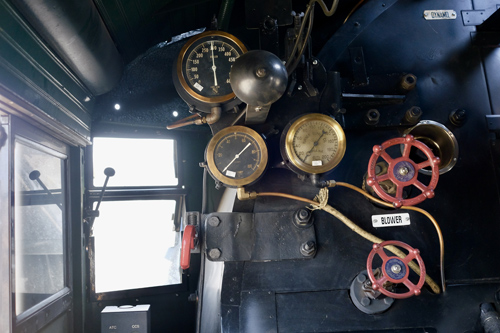 In this colour photograph taken by a member of the crew, three brass-rimmed dials are mounted in front of the fireman’s seat including the locomotive’s boiler pressure gauge.