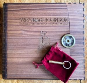 Colour photo of Super-De-Luxe Presentation Box with brass key resting on red velvet pouch.