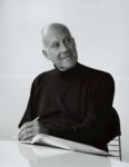 The architect Norman Foster sits with pencil and sketch book in this black-and-white portrait, courtesy of GA/Yukio Futagawa.