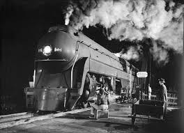 In a black-and-white photograph taken by O. Winston Link in 1957, K2a locomotive No. 127 of the Norfolk & Western Railway makes a stop after crossing the James River in Virginia. 