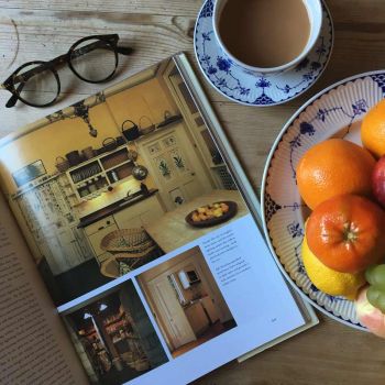 In a picture essay on Kitchens, four colour photographs provide ideas for enhancing otherwise basic rooms with good lighting and decorative touches, such as hand-painted motifs on the doors. 