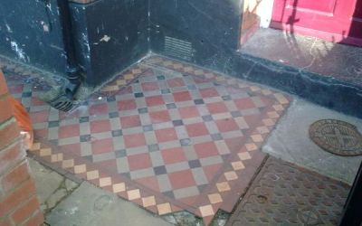 A front entrance shows its age after a century of use