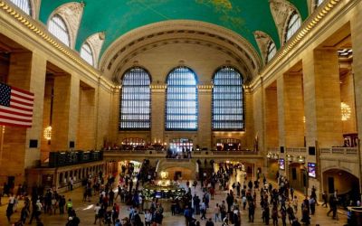 In this colour photograph taken by Ian Logan the magnificent concourse of New York’s Grand Central Terminal is brightly illuminated and thronged with passengers.