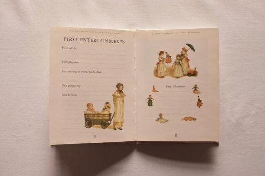 On pages 28 and 29 of The Kate Greenaway First Year Baby Book, decorated with toys and children playing, you can write down the first lullaby you sang, the name of your baby’s first playmate and details of their first holiday and first Christmas.